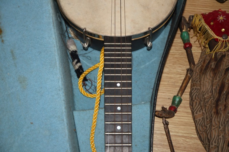 An early 20th century Saxon violin cased with bow and a cased banjo